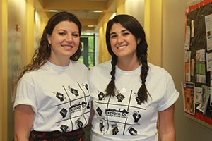 Amanda Riddle and Lauren Pesserini smile in Explore DC shirts as they discuss the program.