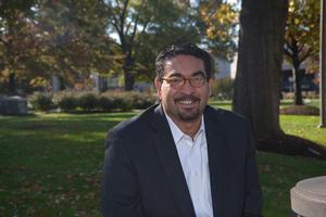 Colin Saldhana sits on the AU quad.