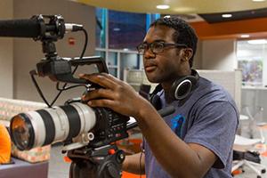 Robert Boyd using a camera with a microphone