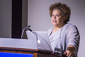 Visiting speaker Alysia Burton Steele stands at lectern