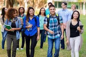 College Students walk on campus together outdoors.