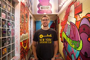 Man standing in hallway with colorful graffiti