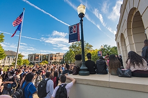 a crowd is gathered on the steps of the Mary Graydon Center