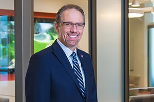 Provost in front of a window.