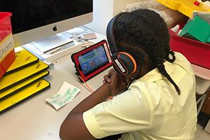 A child studies another language with headphones