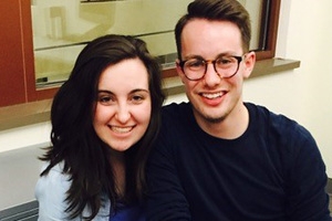 Two Alums, Lex Loro and Emmett Patterson, sitting in front of a window.