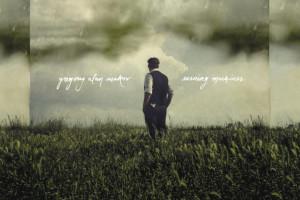 Album art from Gregory Alan Isakov album Evening Machines. Man standing in a field with clouds behind