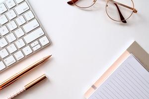 A computer, pen, and paper