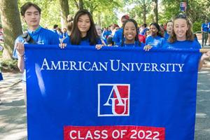 Four students holding up an AU banner for the class of 2022.