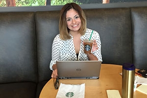 Kenya Alvarado with coffee and laptop