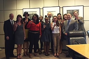 Members of the Key Executive Leadership Program staff hold challenge coins given to them at the US Secret Service Headquarters.