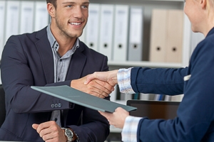 Two business people shaking hands.