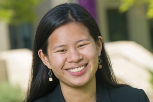 Liliana Zigo seated on campus in front of building.