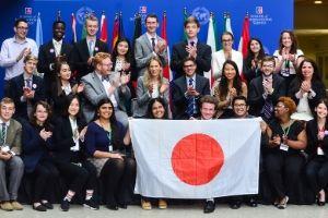 MG20's directors and student staff hold up the Japanese flag.