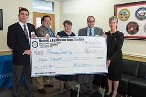 Campus Life Vice President Gail Hanson accepts donation check from Masonic and Eastern Star Home Charities representatives.