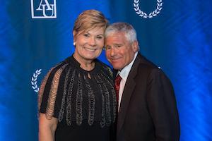 Amy and Alan Meltzer in front of blue AU background