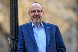 Man with blue sports jacket and glasses