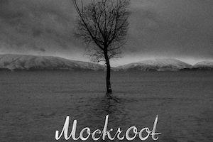 Black and white tree without leaves in front of mountains. Text reads Mockroot