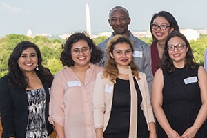 Students stand with Washington Monument in background