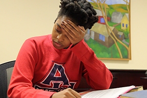 A stressed out student worries over her homework.