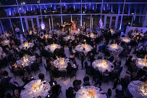 Many elegant tables with fancy lighting.