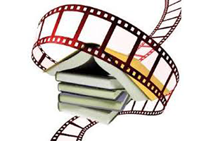 stack of books with a length of movie film wrapped around it.