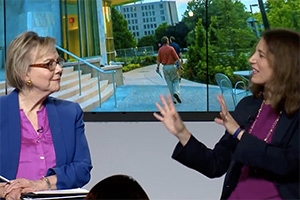 AU president Sylvia Burwell and SOC professor Jane Hall conversing with students