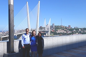 Two students with Russian contact near Vladivostok suspension bridge.