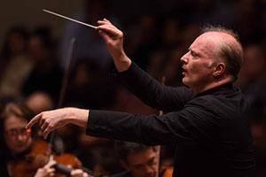 Conductor leads orchestra using baton