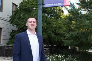 William Dixon standing beneath AU sign