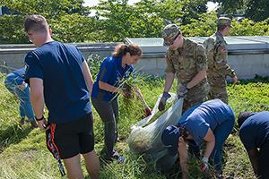 President Burwell and students weeding at AFRH