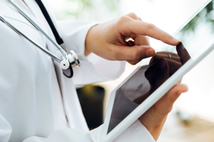 Doctor's finger on a tablet