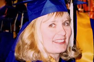 woman in cap and gown at graduation