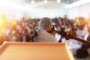 A microphone at a podium in front of a lecture hall