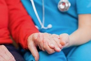 doctor holding patient's hand