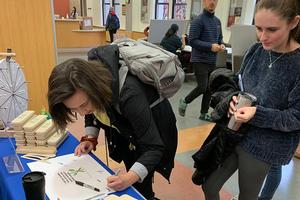 Students signing a pledge to not use single-use plastics
