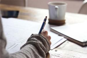 person writing on a desk