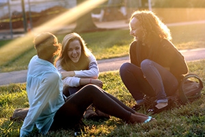 Students sit outside