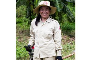 Phetsamay Sichanthavong of Lao National Unexploded Ordnance Programme (UXO Lao) standing in a field Phetsamay Sichanthavong of Lao National Unexploded Ordnance Programme (UXO Lao) standing in a field