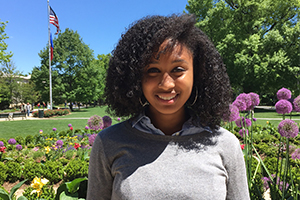 Asha Smith, Harold Johnson Award winner standing in the quad