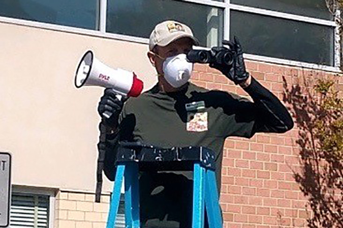 Man on a ladder with a megaphone