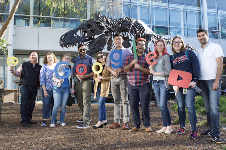 John Morada (left) and students hold up letters that spell out 'Google'.