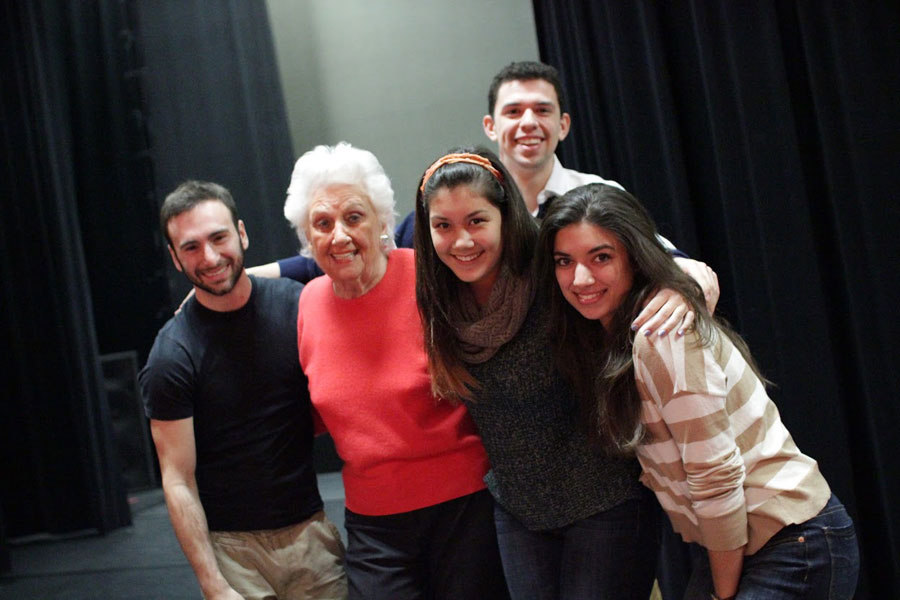 Theatre students embracing Sylvia Greenberg.