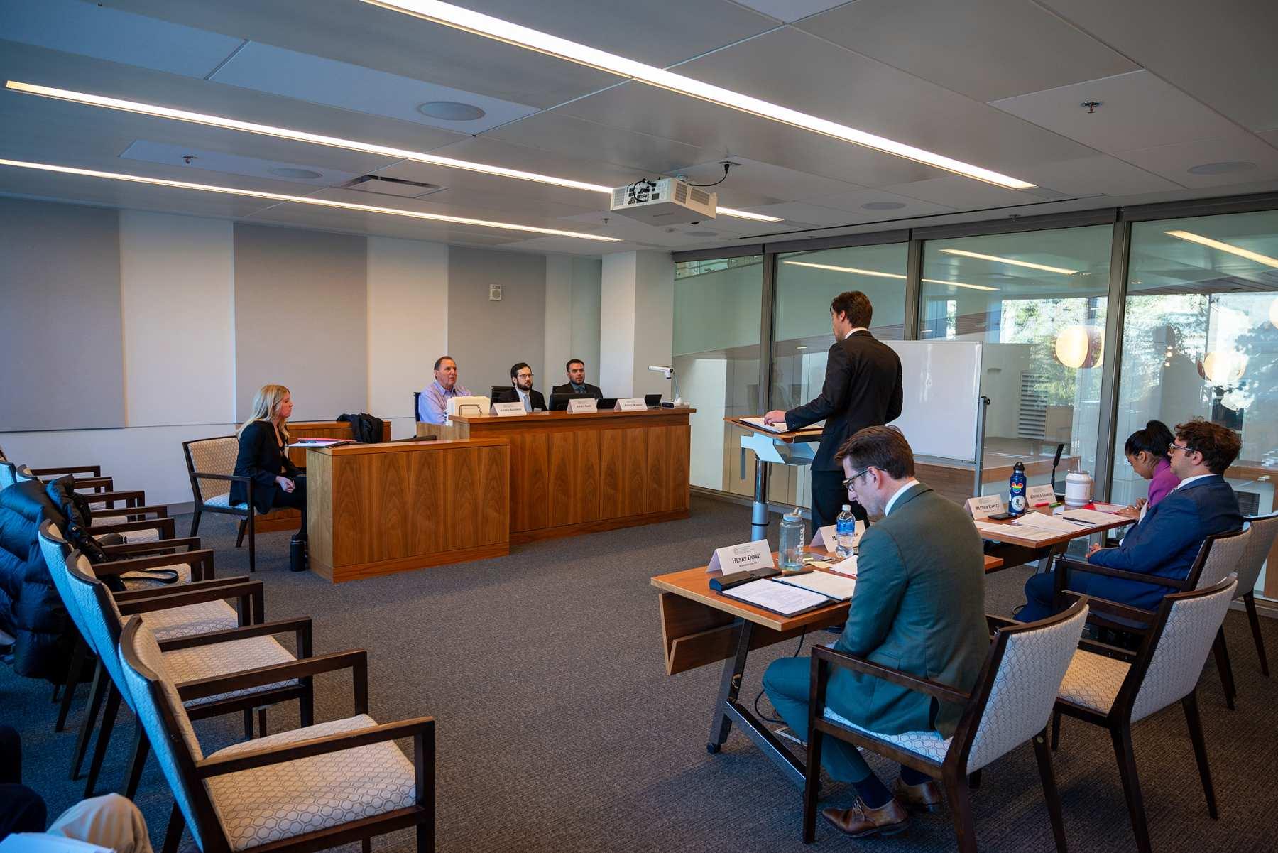 A moot court participant makes their case to the judges. A moot court participant makes their case to the judges.